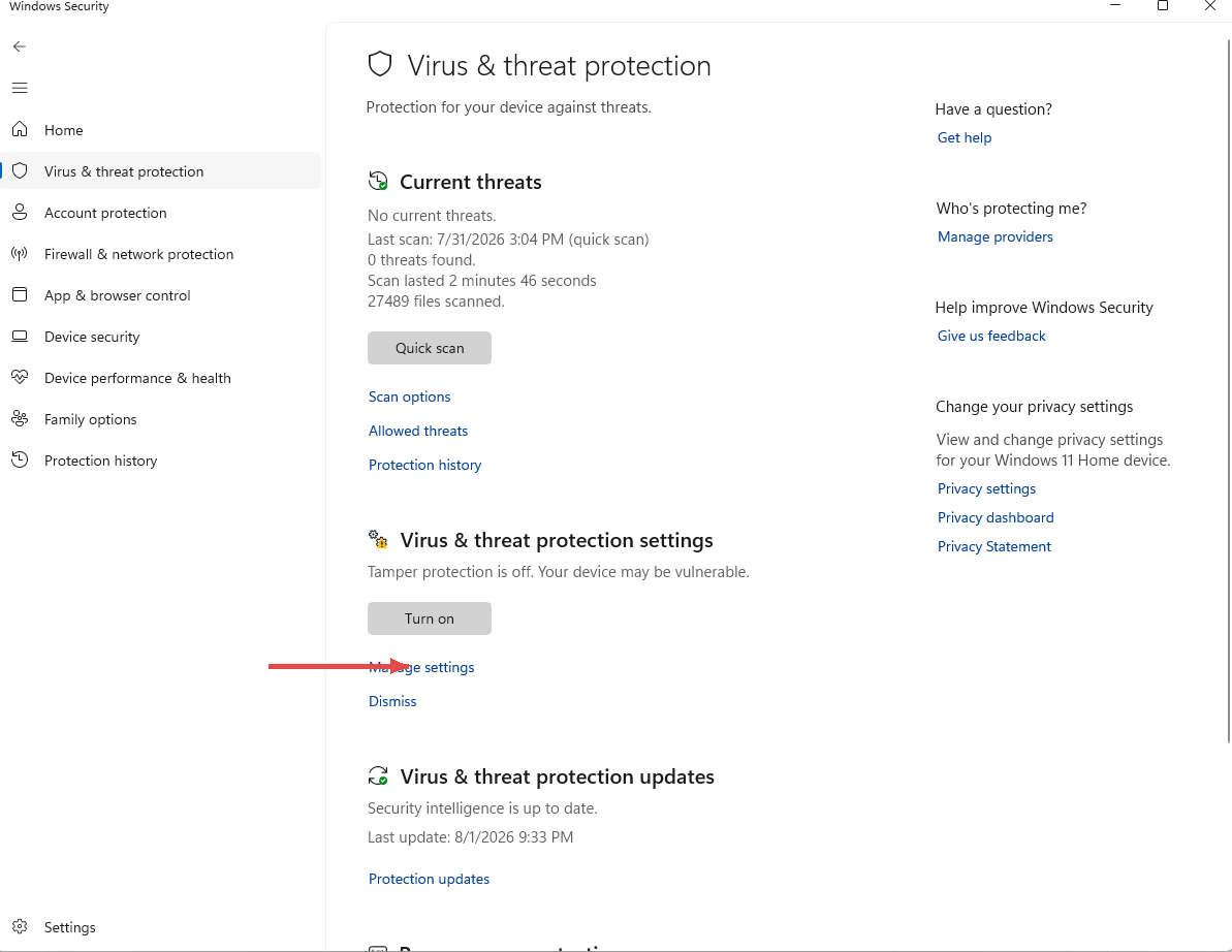 Virus and threat protection page with a red arrow pointing at the Manage settings link